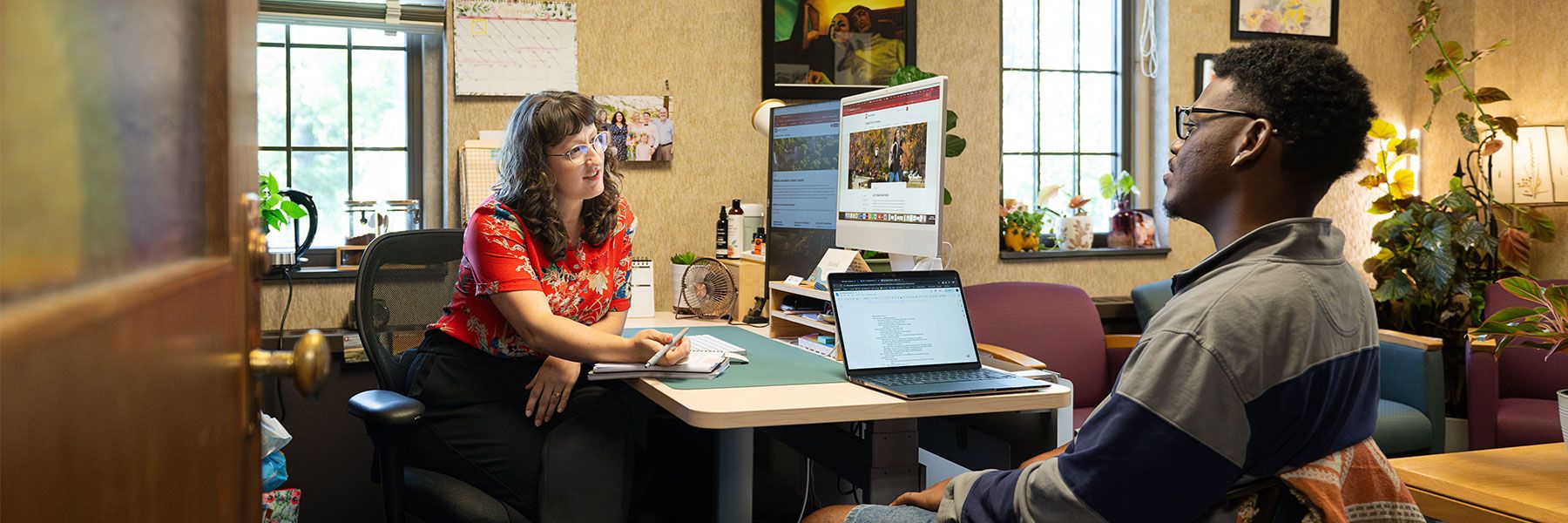 Two people talking across a desk