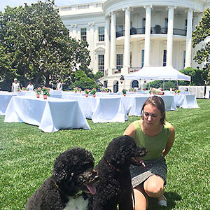 Photo of Morgan Mohr outside the White House with Obama's dogs, Bo and Sunny.